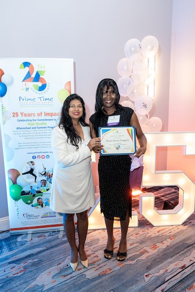 Prime Time's well-being and life skills specialist (left) honors cohort graduate (right) at Prime Time's Afterschool Symposium. 